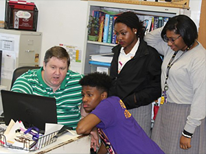 LADC-GEMM_Leftwich_Easton group_slider Study author and physics instructor Kendal Leftwich (L) discusses marine mammal acoustic data with students from Warren Easton Charter High School in New Orleans, Louisiana. Photo provided by Kendal Leftwich.