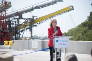 Scripps Oceanography Director Margaret Leinen speaks at the unveiling of the new pier at Scripps's Nimitz Marine Facility on Point Loma in April 2016. Behind her are the boom arms of research platform FLIP. Credit: Scripps Institution of Oceanography at UC San Diego, used here with permission