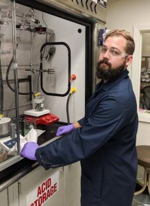 Tulane University Ph.D. student Chris Keller works at the chemical fume hood, where he assembles and observes reactions between nanoparticles and polymers designed to help disperse spilled oil. (Photo by McKenna Redding)