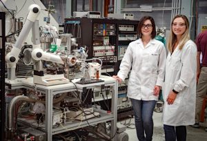 Dr. Martha Chacon (left) and Ph.D. student Sydney Niles (right) stand next to the custom-built 9.4 Tesla FT-ICR MS used for molecular-level analysis of petroleum compounds. (Photo credit: Stephen Bilenky)