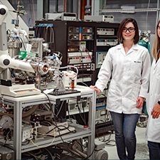 9p4T-Martha-and-Sydney_slider Dr. Martha Chacon (left) and Ph.D. student Sydney Niles (right) stand next to the custom-built 9.4 Tesla FT-ICR MS used for molecular-level analysis of petroleum compounds. (Photo credit: Stephen Bilenky)