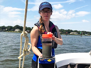 CSOMIO_Scholar_Tarpley1_slider Virginia Institute of Marine Science Ph.D. student Danielle Tarpley holds a sediment core collected from the Lynnhaven River in Virginia. (Photo courtesy of Jessica Turner)