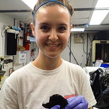 DEEPEND_Scholar_Slayden1_slider Nova Southeastern University master’s student Natalie Slayden holds a common fangtooth (Anoplogaster cornuta) that was collected during the DEEPEND consortium DP06 research cruise in the Gulf of Mexico. (Photo by Nina Pruzinsky)