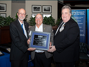 Sutton Provost Award 2019_slider From left to right: Dr. Richard Dodge, Dean of Halmos College of Natural Sciences and Oceanography; Dr. Tracey Sutton, recipient of Nova Southeastern University’s (NSU) 9th Annual Provost’s Research and Scholarship Award; and Dr. Ronald J. Chenail, NSU Interim Provost and Executive Vice President of Academic Affairs. Photo used with permission from Joe Donzelli, Associate Director NSU Office of Media Relations.