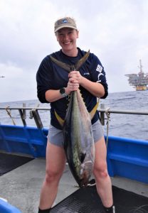 University of South Florida master’s student Madison Schwaab holds a yellowfin tuna caught for subsampling and subsequent contaminant analysis. (Provided by Madison Schwaab)