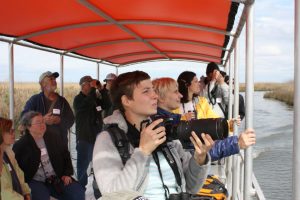Participants try to get a good look at bird species that call the marsh home during a boat tour of the salt marsh. Image Credit: Murt Conover, LUMCON and CWC.