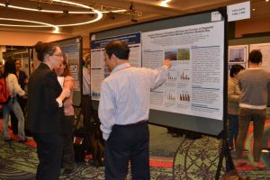 Gulf of Mexico researchers discuss research presented during a poster session. Image Credit: Chris Kirby, GoMRI Management Team.
