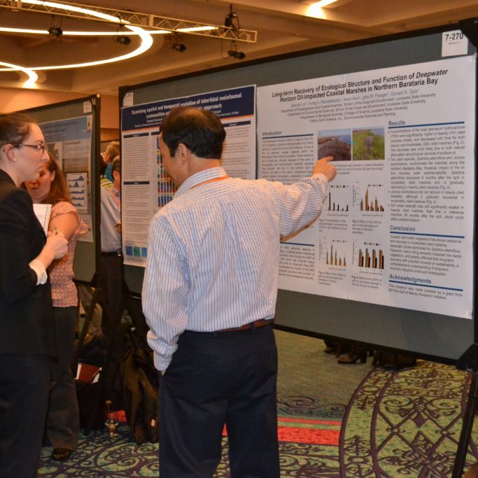 Gulf of Mexico researchers discuss research presented during a poster session. Image Credit: Chris Kirby, GoMRI Management Team. Gulf of Mexico researchers discuss research presented during a poster session. Image Credit: Chris Kirby, GoMRI Management Team.