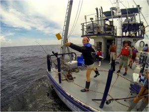 Deep-C summer intern and University of West Florida student Katie Vaccaro throws out a drift card on her Gulf research cruise with Dr. Richard Snyder. Photo Credit: Deep-C.