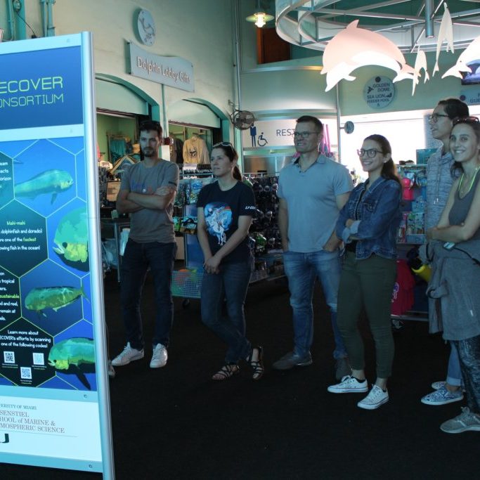 IMG_7990 Members of the RECOVER research team visit the RECOVER exhibit at the Miami Seaquarium. The exhibit provides an overview of the RECOVER consortium, video displays highlighting their research, and a visualization of mahi mahi’s rapid growth in the early stages of its life. Photo Credit: RECOVER.