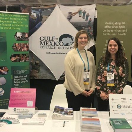 Pic 5 Callan Yanoff (left, GoMRI Management Team) and Rosalie Rossi (right, GRIIDC Program Manager) at the GoMRI/GRIIDC booth at the 2019 AGU Fall Meeting in San Francisco, California. . Photo Credit: Leigh Zimmermann